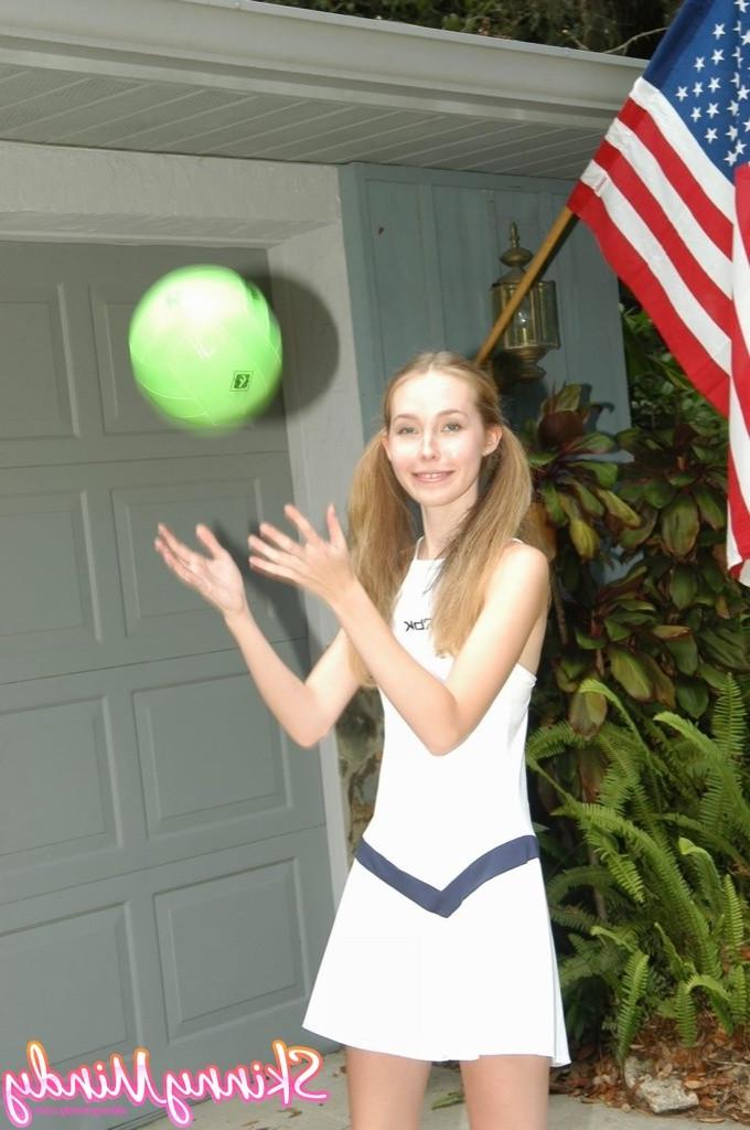 16P Skinny teen girl in pigtails outdoors playing with ball